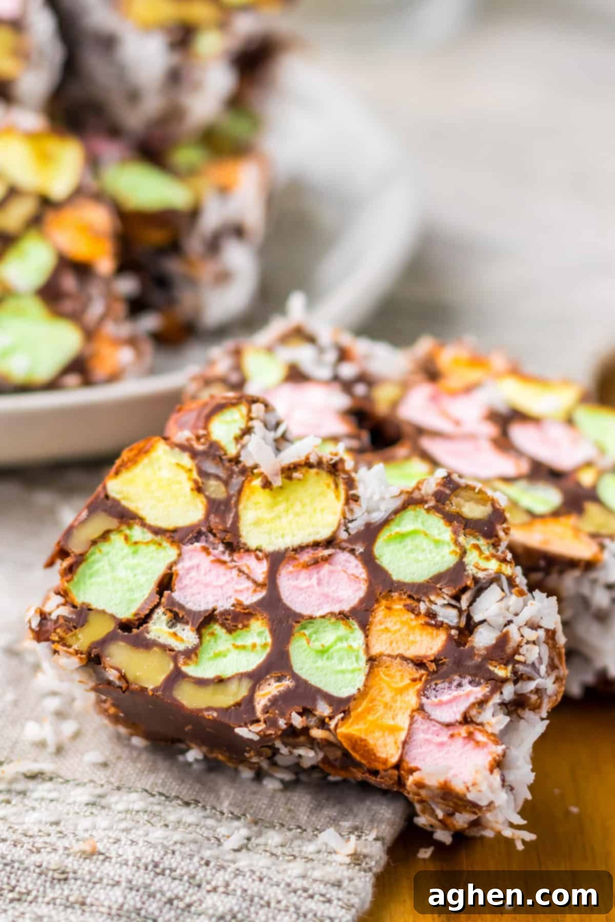 Close-up of marshmallow-studded church window cookies with colorful mini marshmallows, chocolate, and a shredded coconut coating.