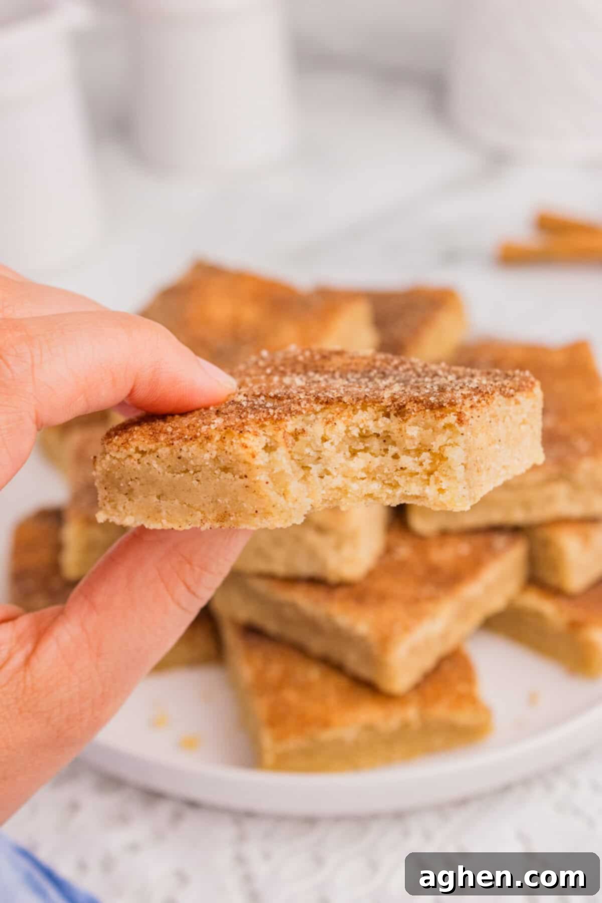 Thick snickerdoodle cookie bar with bite taken out of it.