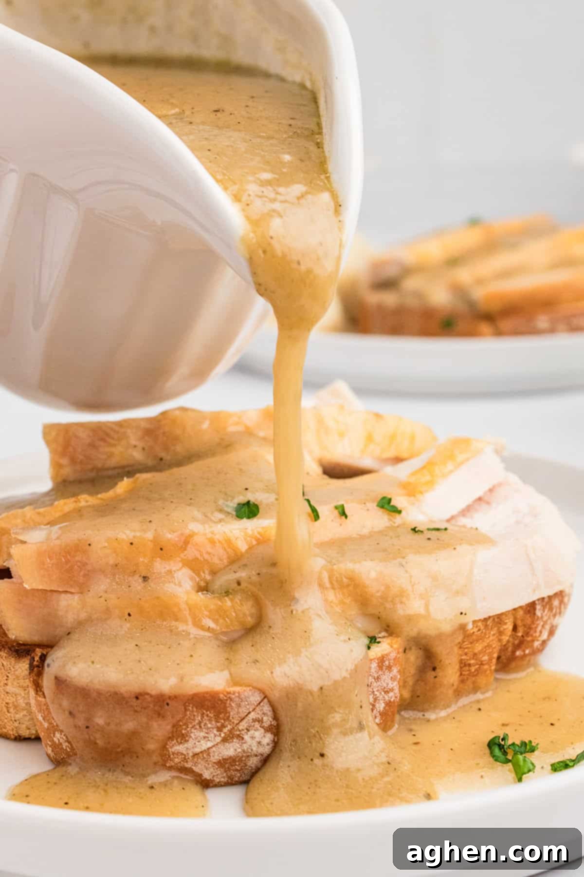 Open Faced Turkey Sandwich 6 Gravy being poured generously over open faced turkey sandwich.