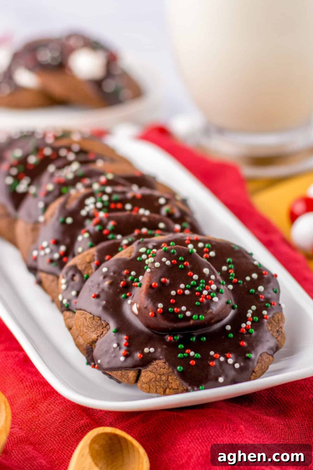 Plate of hot chocolate cookies with marshmallows and chocolate icing, perfect for holiday gatherings.