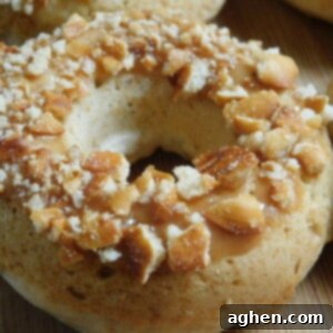 A top-down view of a baked caramel pretzel donut, garnished with pretzel crumbs.
