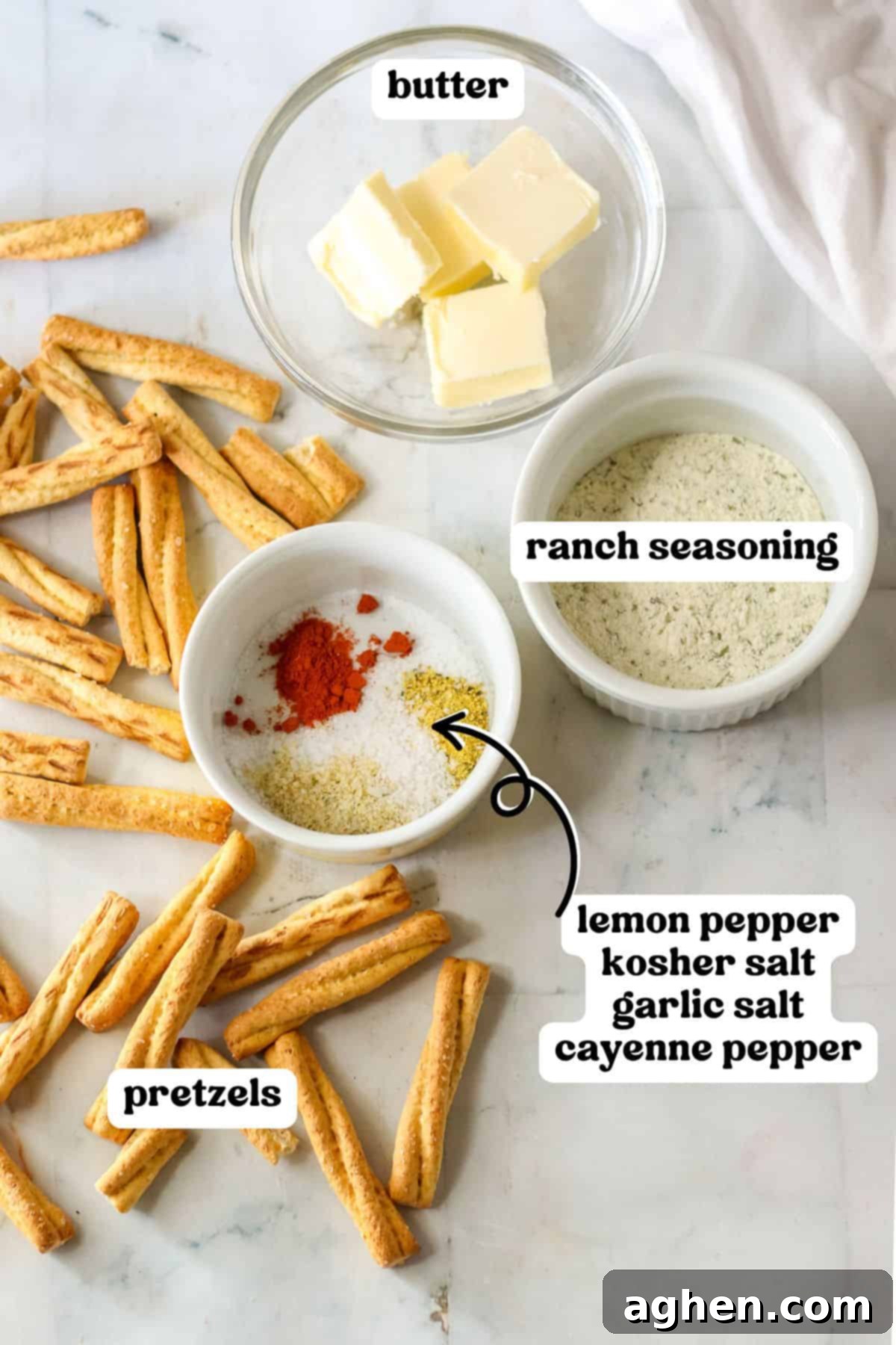 Spiced Pretzel Rods 3 Ingredients for seasoned pretzels, including butter, ranch seasoning, and various spices, neatly arranged with pretzel sticks on a wooden surface.