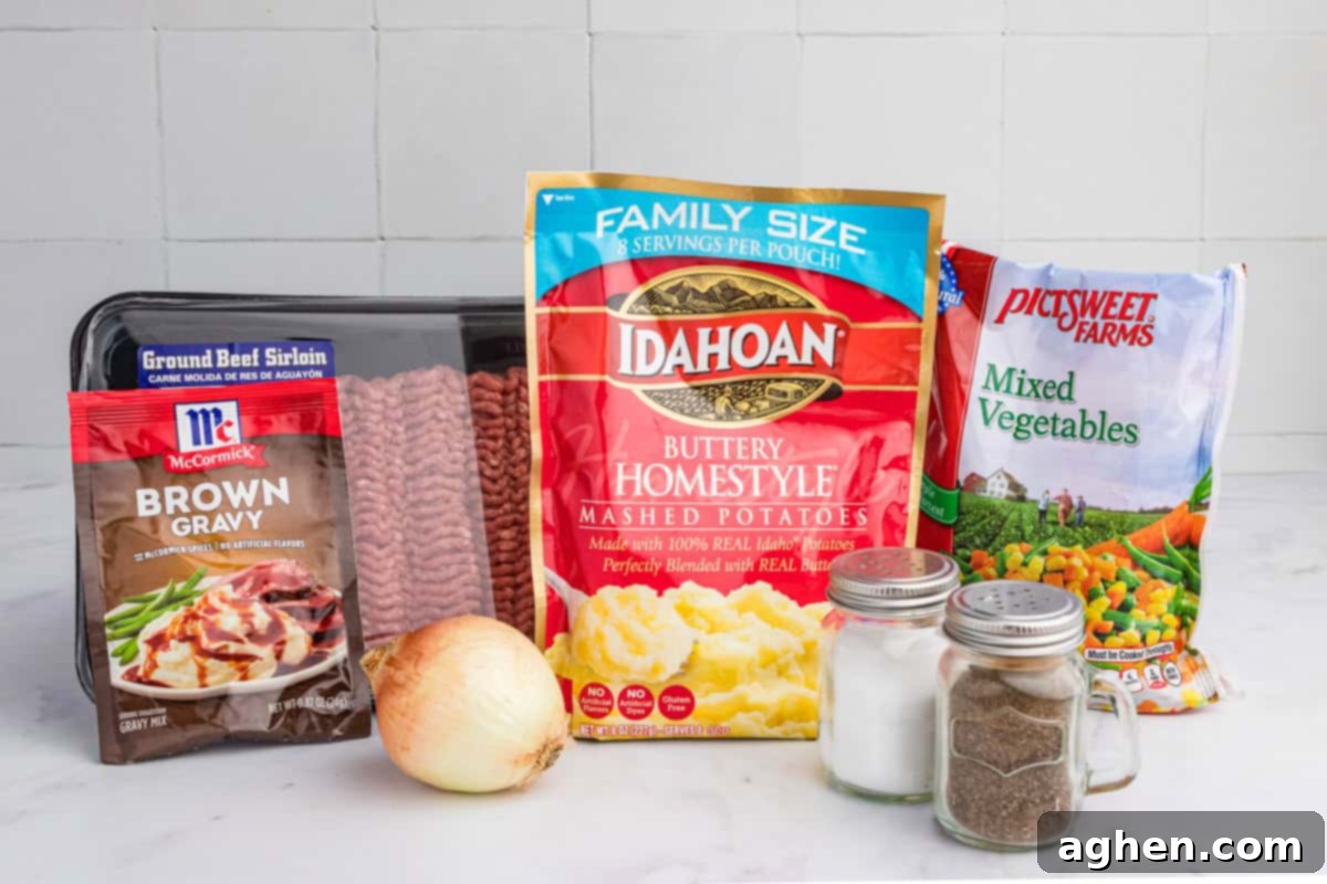 No-Fuss Cottage Pie 4 A neatly arranged selection of cottage pie ingredients, featuring a package of ground beef sirloin, McCormick brown gravy mix, Idahoan buttery mashed potatoes, a bag of frozen mixed vegetables, a whole onion, and two glass shakers of salt and pepper.