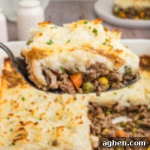 No-Fuss Cottage Pie 10 A close-up shot of a spoonful of cottage pie, highlighting the creamy mashed potato topping and hearty beef and vegetable filling, with the casserole dish in the background.