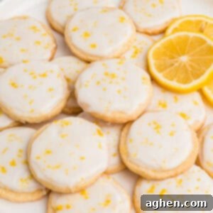 A plate of slice and bake lemon shortbread cookies with lemon glaze.