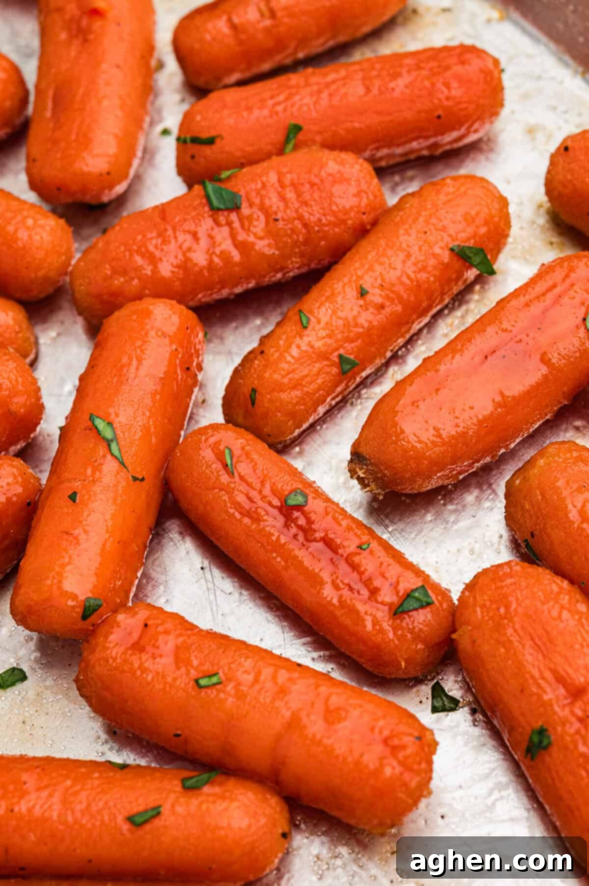 Brown sugar honey glazed carrots on metal sheet pan.