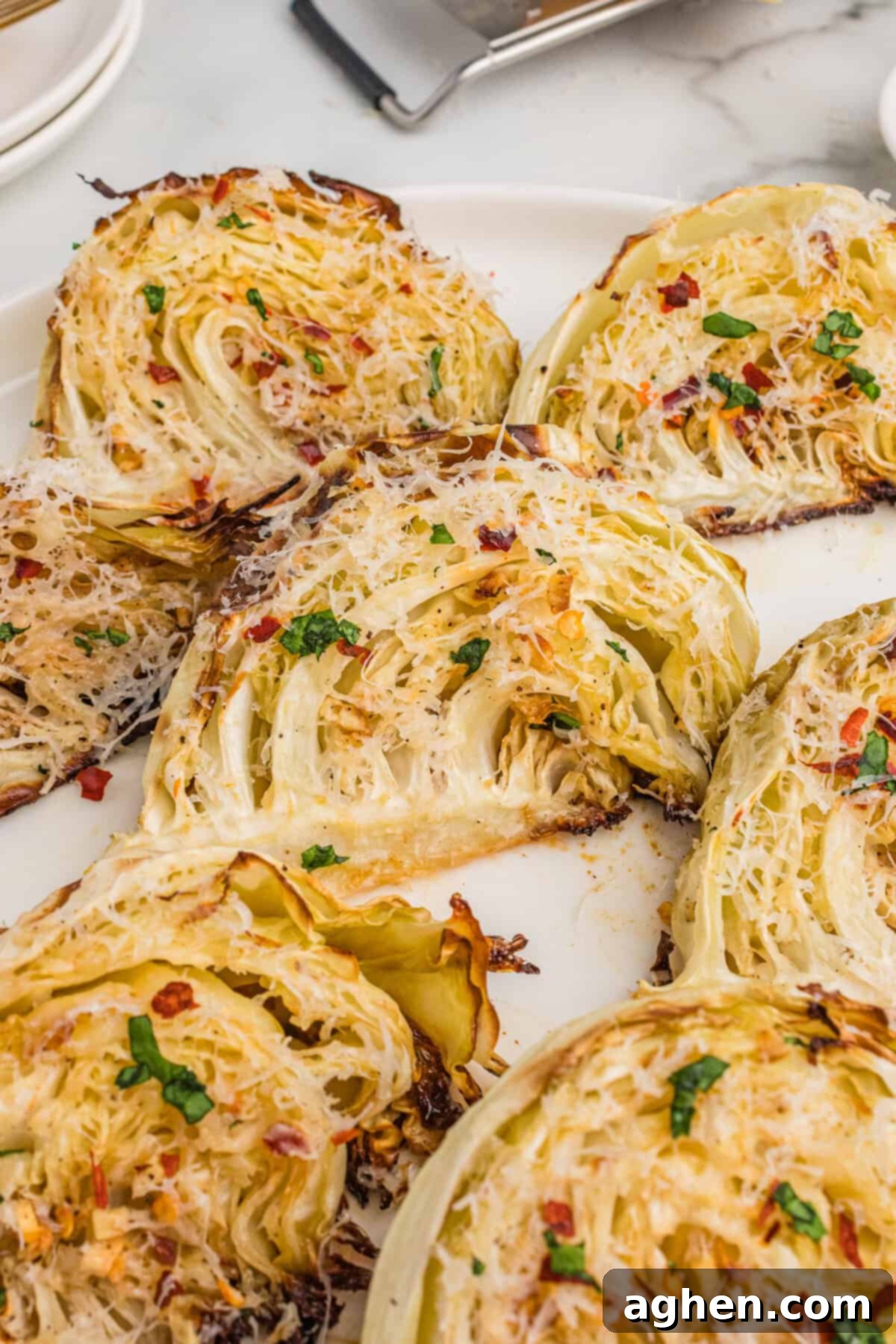 Golden Roasted Cabbage Wedges 8 Overhead view of roasted cabbage wedges with garlic, parmesan cheese, and red pepper flakes.