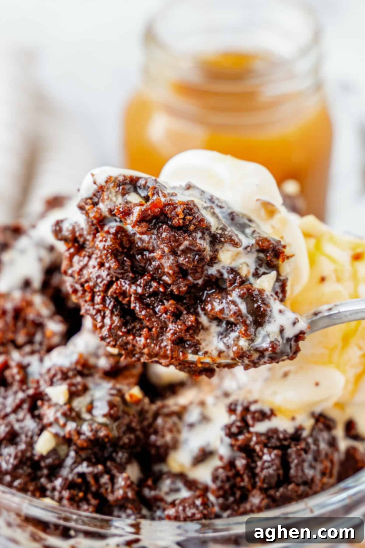 Effortless Chocolate Indulgence 6 Spoon holding a bite of chocolate dump cake and ice cream.