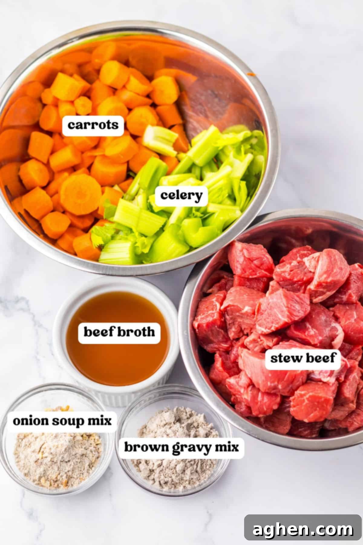 Labeled ingredients in bowls: sliced carrots and chopped celery, raw cubed stew beef, beef broth, onion soup mix, and brown gravy mix.