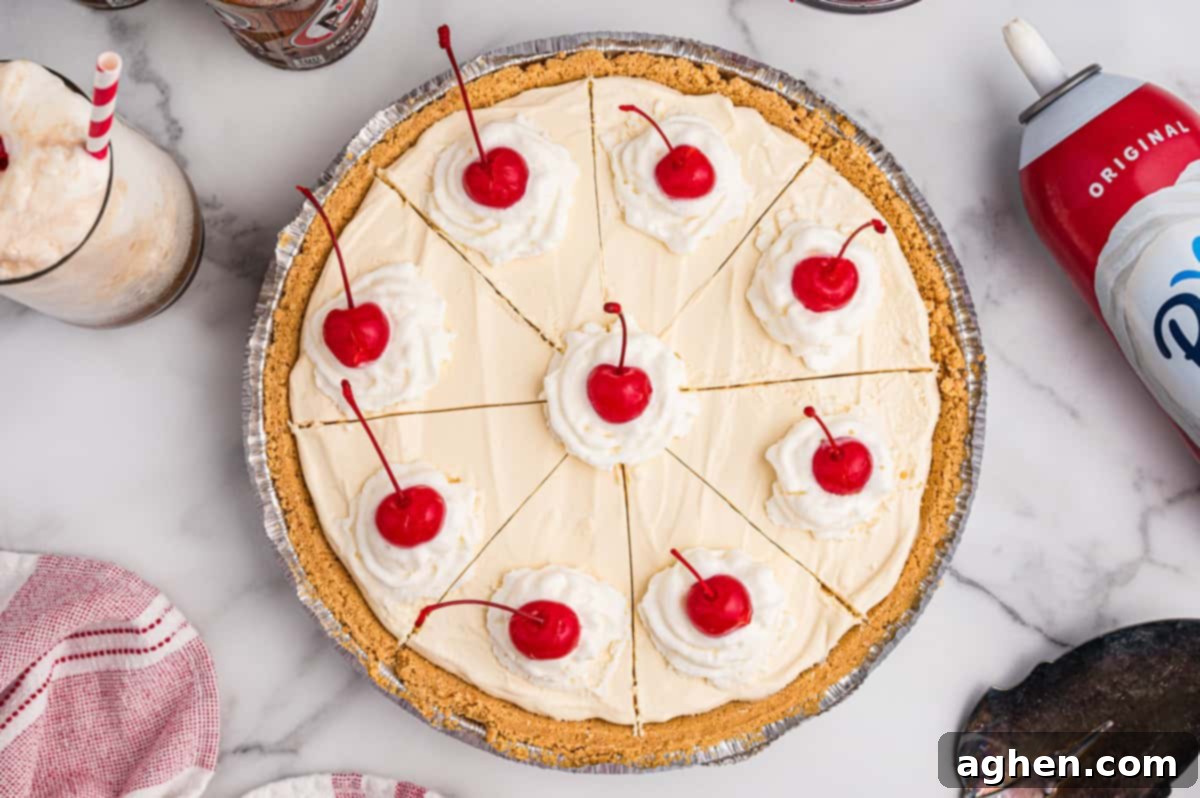 A whole frozen root beer float pie, neatly sliced into 8 perfect pieces, each elegantly topped with a dollop of whipped cream and a vibrant maraschino cherry, ready to serve.