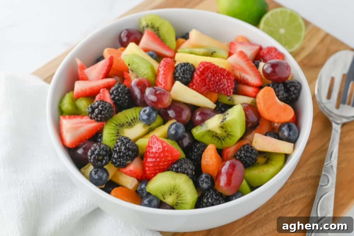 Side view of fruit salad in a white bowl.