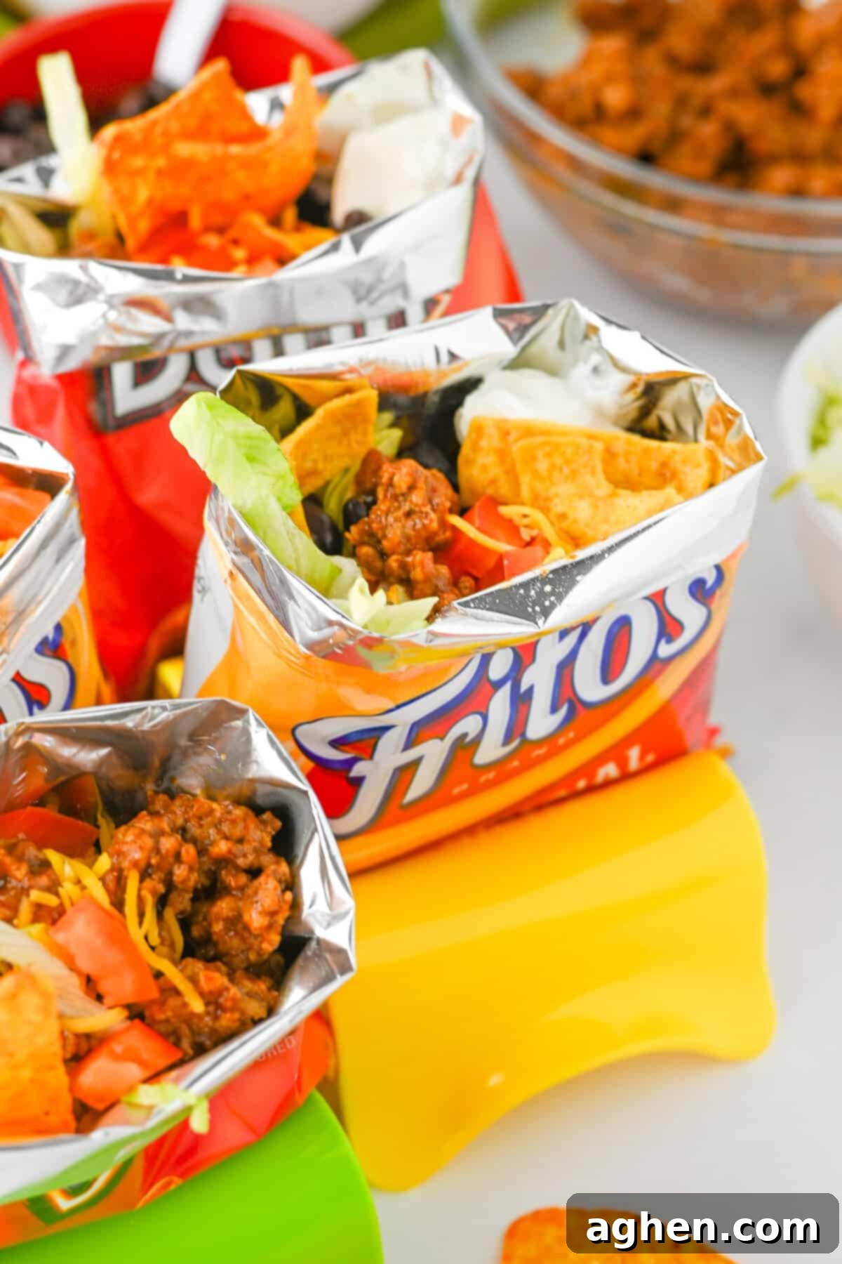 Delicious Fritos walking taco, brimming with seasoned ground beef, shredded cheese, black beans, crisp lettuce, and a dollop of sour cream.