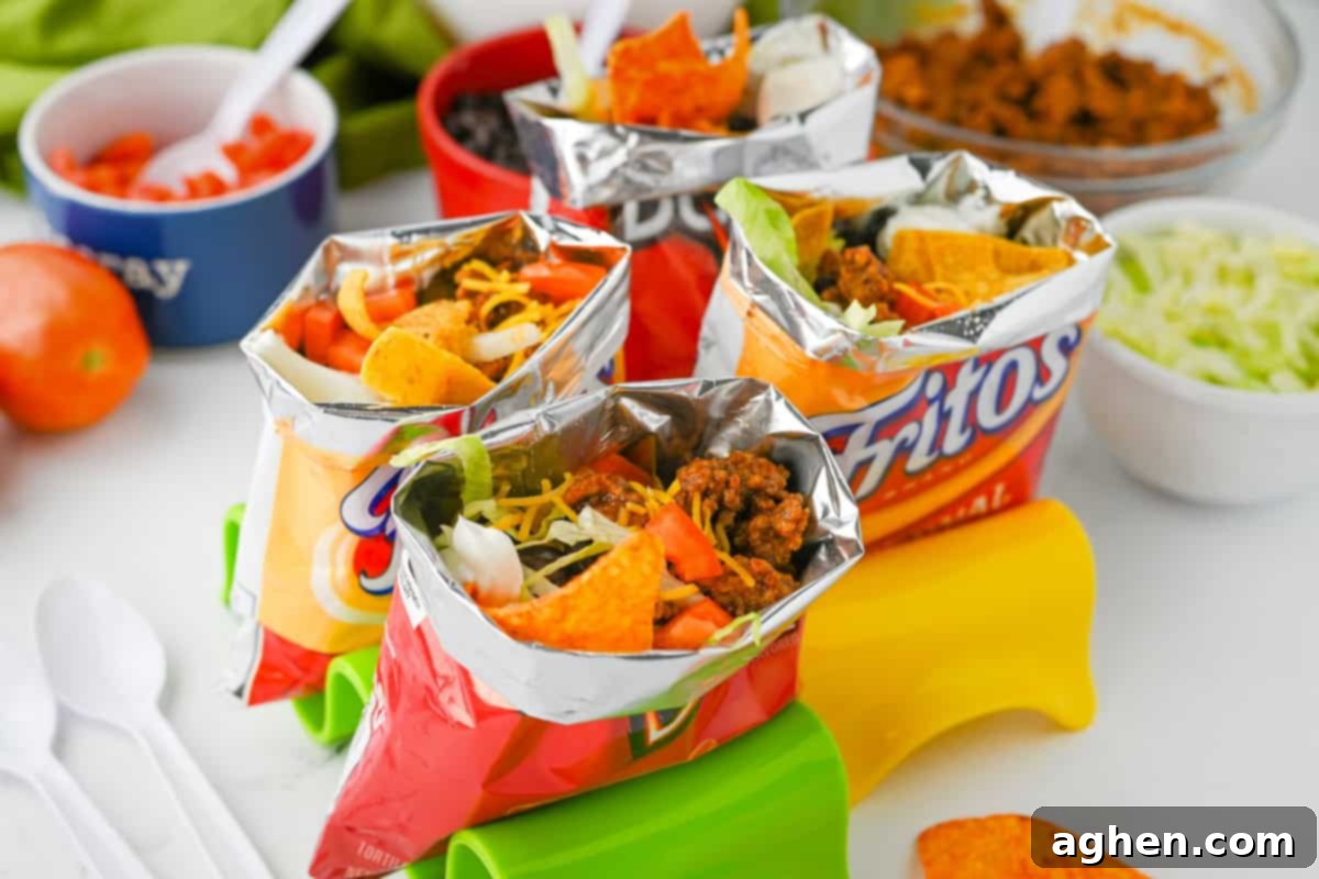 A vibrant collection of individual walking tacos, each served in its own chip bag, showcasing a variety of delicious fillings and toppings.