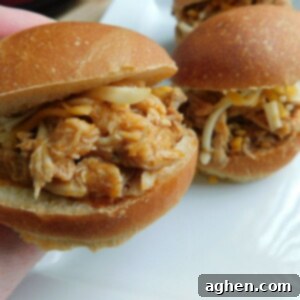 Spicy Buffalo Pulled Pork with Crispy Bacon 2 Buffalo pulled pork with bacon cooking in a slow cooker.
