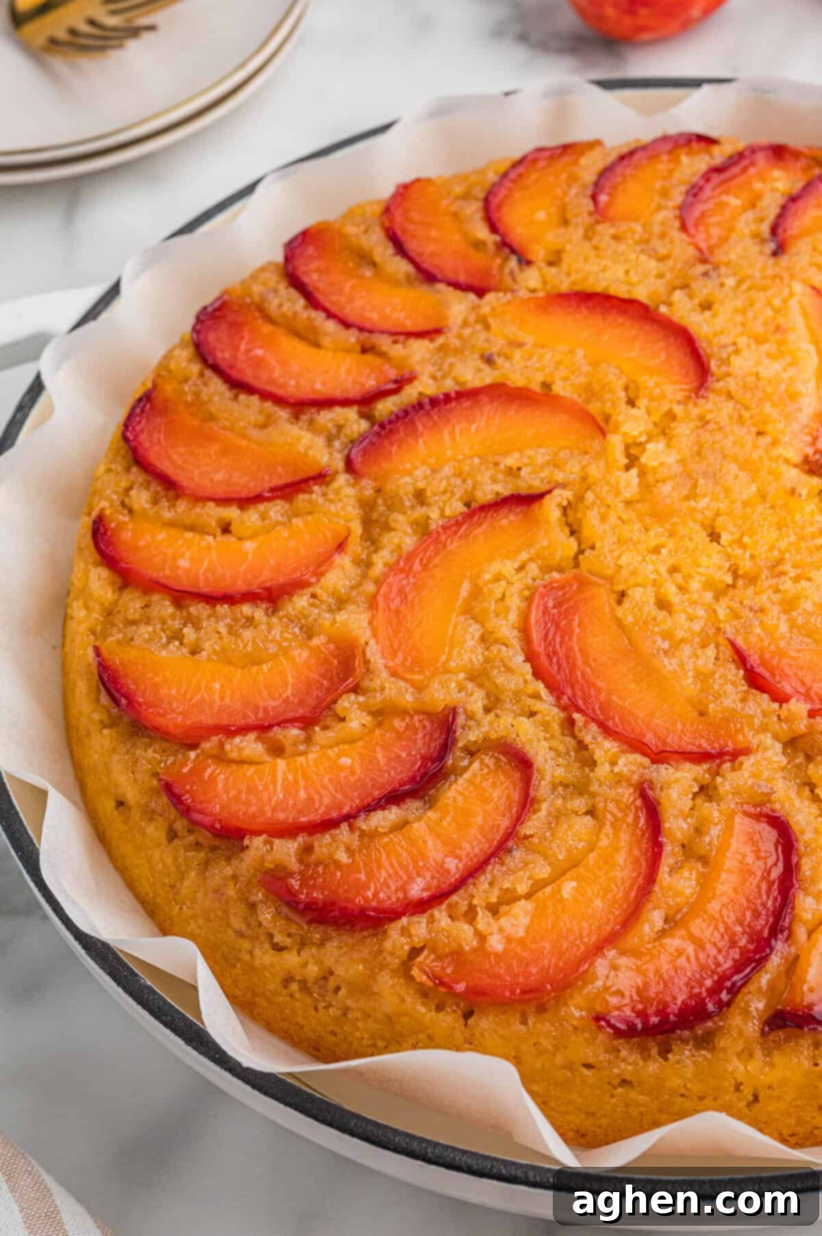 Foolproof Peach Upside Down Delight 8 An upside down peach cake made with cake mix, showing the detailed placement of peach slices on top and the golden, fluffy texture of the baked cake.