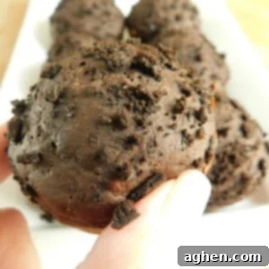 A freshly baked chocolate cookie crumble muffin, top-down view.