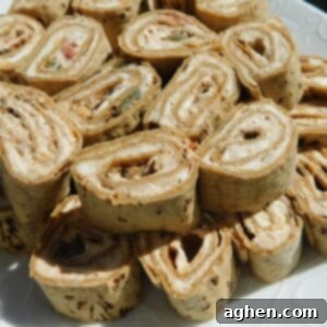 Cheesy Nacho Pinwheels 3 Close-up of a neatly sliced Nacho Dip Roll-Up, revealing the creamy, flavorful filling and the Flatout bread wrap.