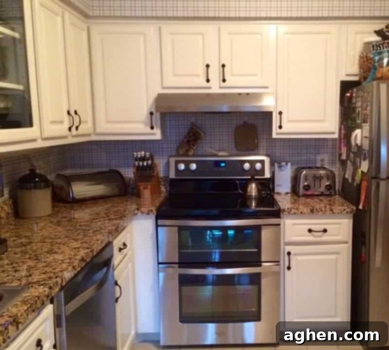 Kitchen with faux granite countertop film installed.