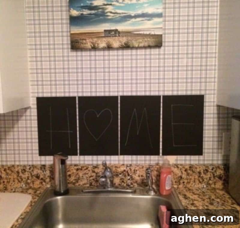 Black chalkboard stickers spelling "home" above kitchen sink.