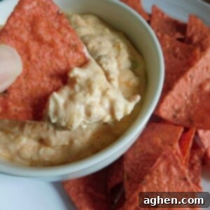 dipping chip into buffalo chicken dip