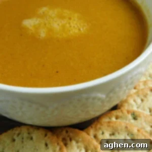 A small bowl of creamy yellow soup.