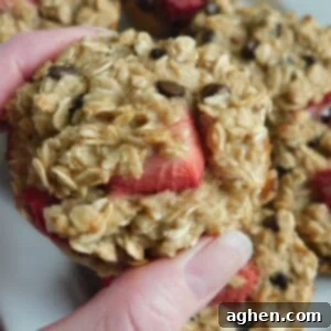 Sunrise Strawberry Oat Muffins 6 Close-up of a perfectly baked strawberry oatmeal muffin in a paper liner