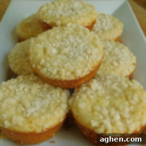 Close-up of a lemon crumb muffin, showing the textured crumb topping