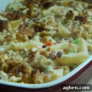Creamy Chicken Caesar Pasta Bake 2 Close-up of a serving of Chicken Caesar Pasta Bake with a fork, showing the creamy texture and toppings.
