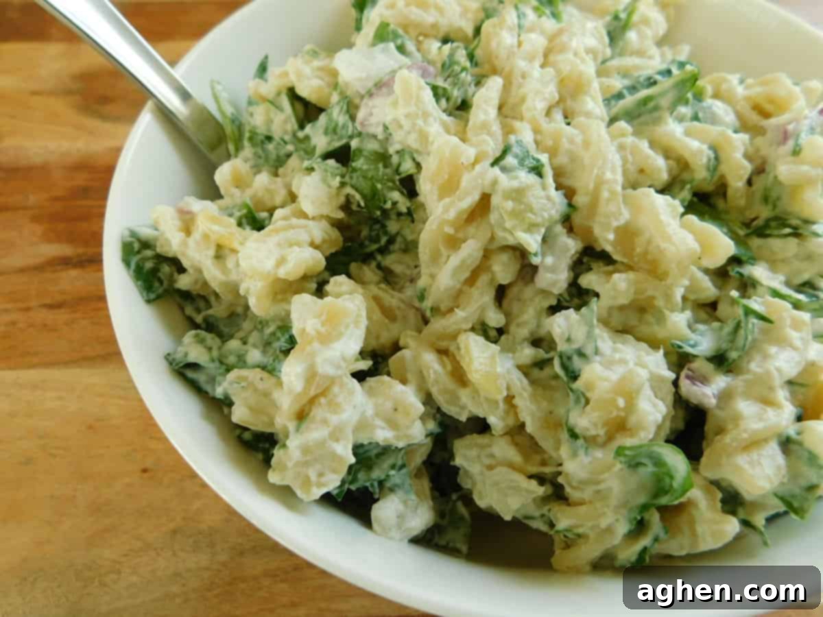 31 Delicious Healthy Sides for Any Meal 12 Spinach and artichoke pasta salad in white bowl