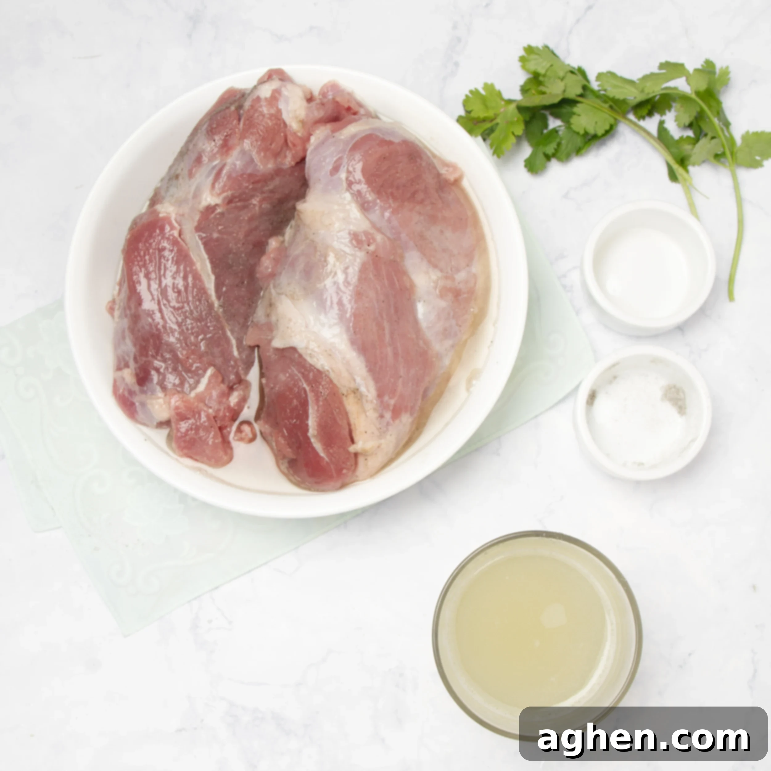 Pineapple Salsa Pork Tenderloin Feast 4 Raw pork tenderloins with pineapple marinade in a shallow dish.