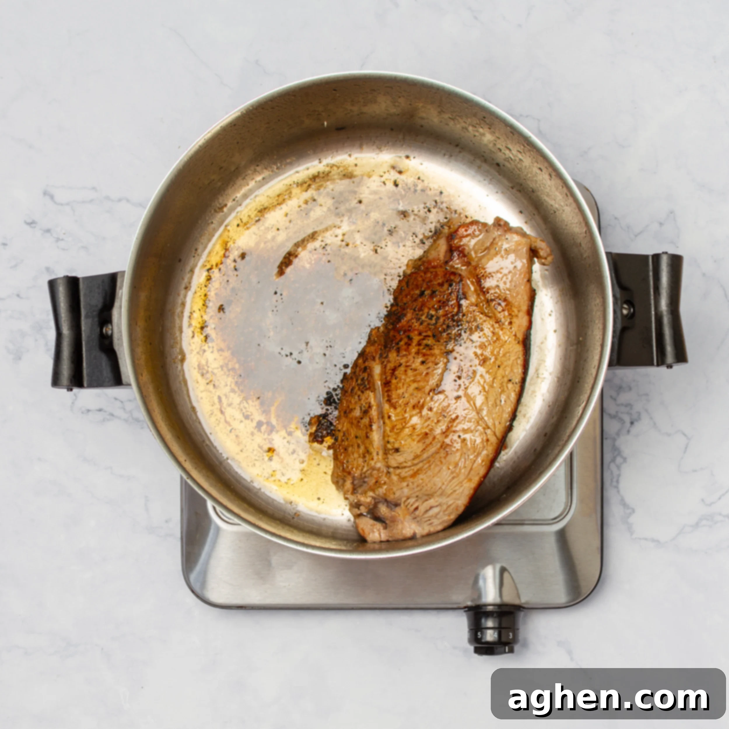 Pineapple Salsa Pork Tenderloin Feast 6 Marinated pork tenderloin cooking in a pan.