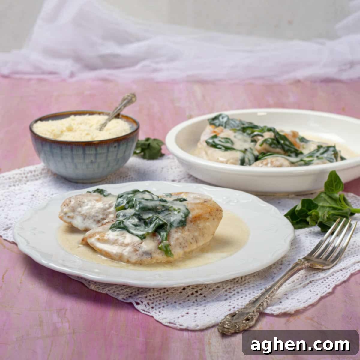 Luscious Light Chicken Florentine 2 Creamy chicken Florentine topped with sauteed spinach on a plate, garnished with fresh parsley.