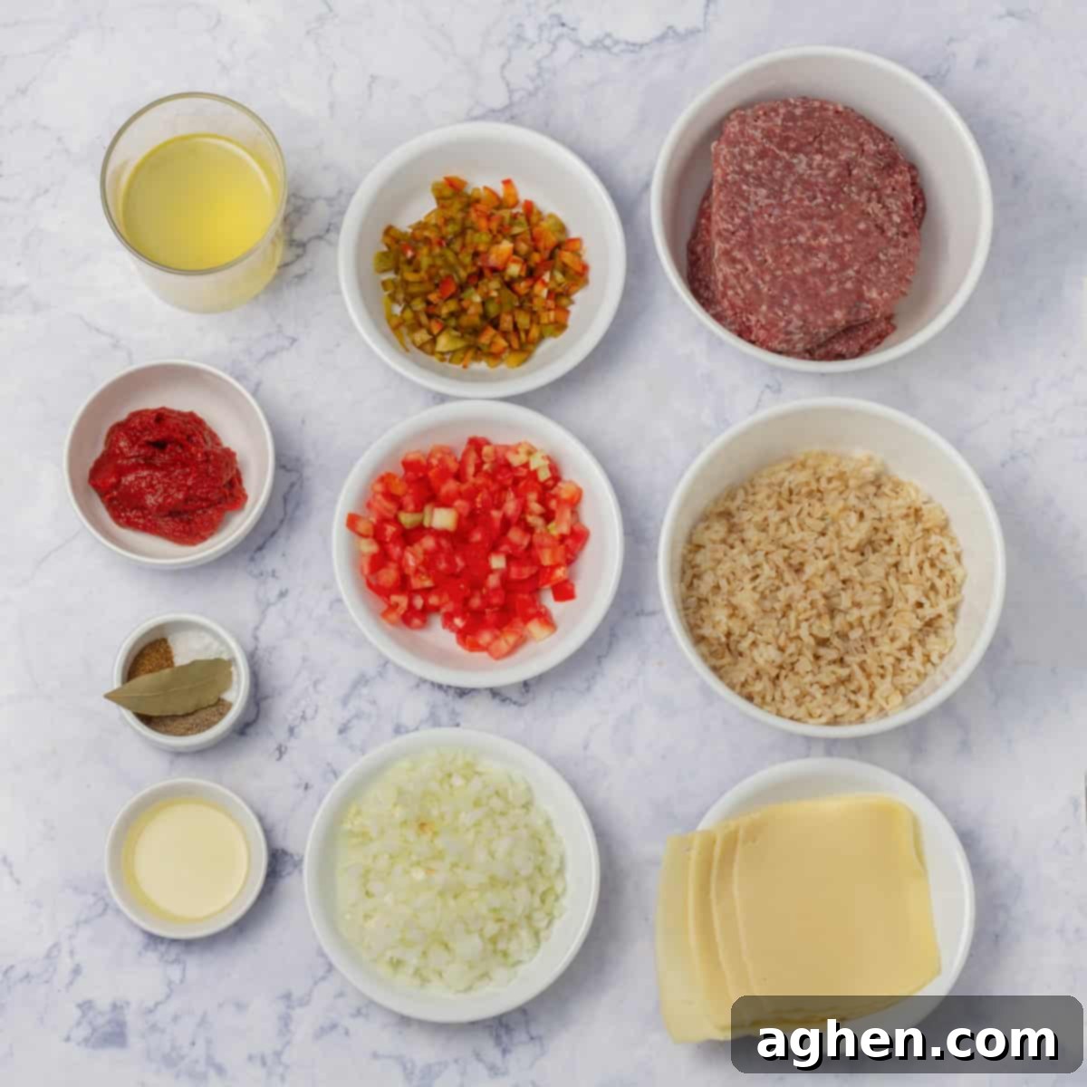 Quick-Fix Stuffed Pepper Casserole 3 Stuffed pepper casserole ingredients of ground beef, chopped onion and peppers, chopped tomatoes, tomato paste, and seasonings in separate dishes.