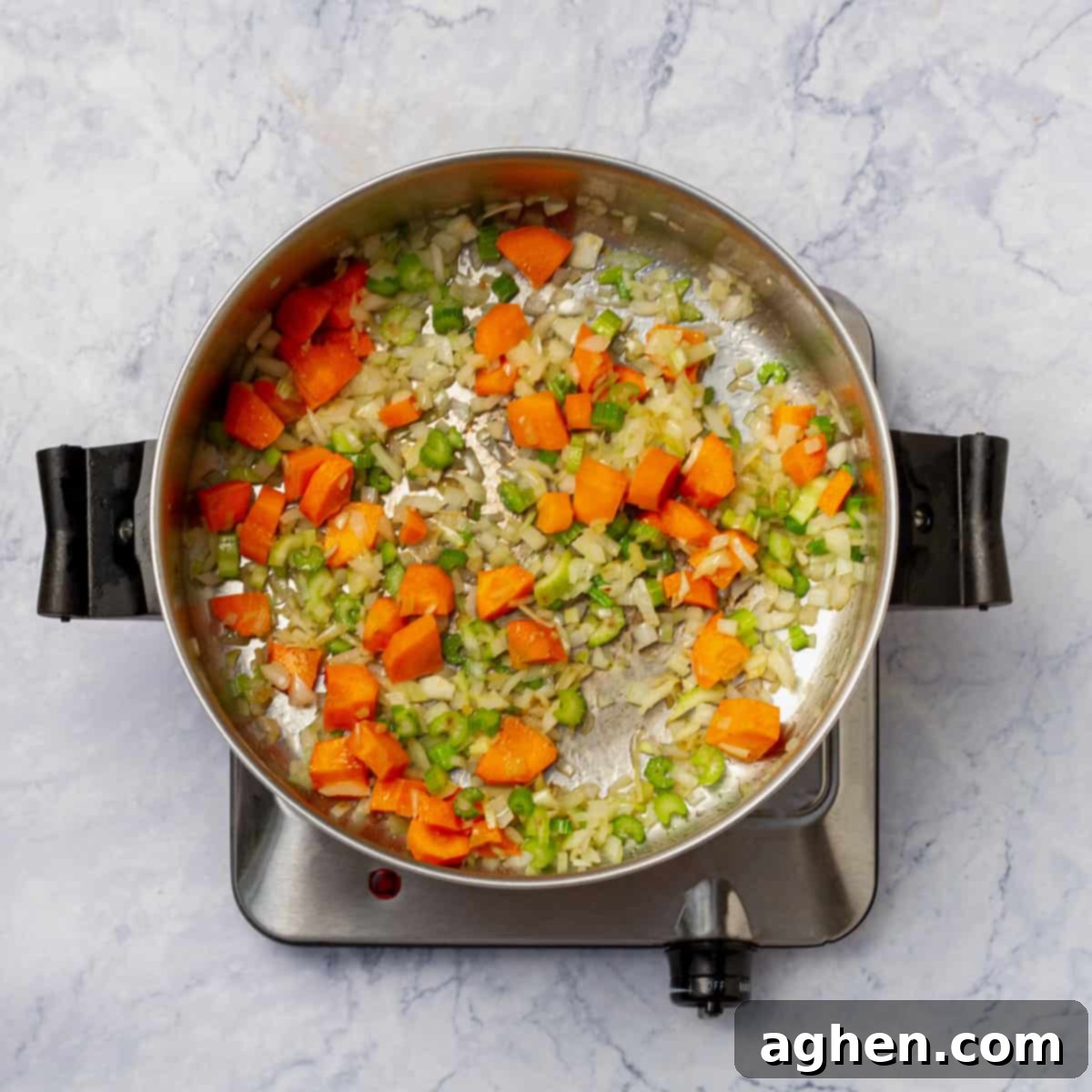 Wholesome Chicken Enchilada Soup 4 A colorful medley of chopped carrots, celery, and onion, along with dried oregano, gently sautéing in shimmering olive oil within a large pot, the steam subtly rising, indicating the development of foundational flavors for the soup.
