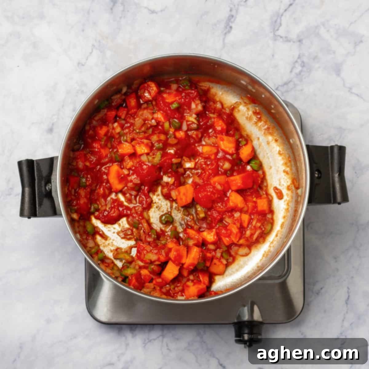 Wholesome Chicken Enchilada Soup 5 Vibrant red diced tomatoes, still in their juices, being added to the pot with the sautéed carrots, celery, and onion, ready to be stirred into the simmering soup base.