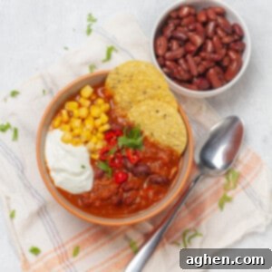 Wholesome Chicken Enchilada Soup 7 Hearty and nourishing chicken enchilada soup in a bowl, topped with crispy tortilla chips, fresh cilantro, and a dollop of sour cream.