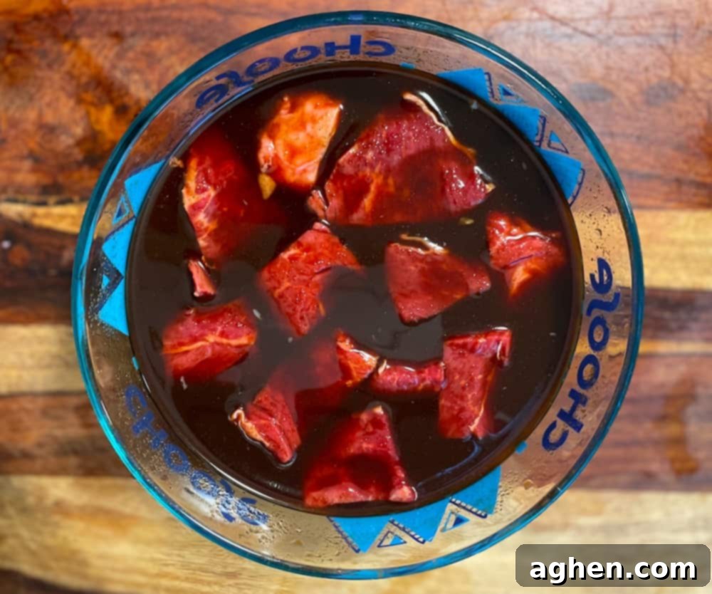 12 Steps to Mastering Your Big Green Egg's Ultimate Accessory 5 steak marinating in a bowl