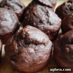 Decadent Double Chocolate Banana Muffins 2 Close-up of a double chocolate banana muffin, showing its moist texture and chocolate chips.