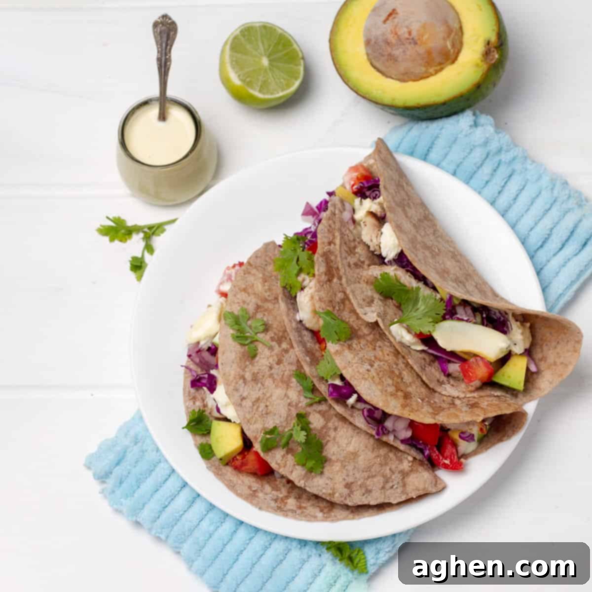 Effortlessly Delicious Weight Watchers Fish Tacos 2 Fish Tacos plated with Yogurt Sauce