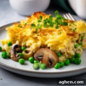 Delicious tuna casserole on a white plate with a side salad