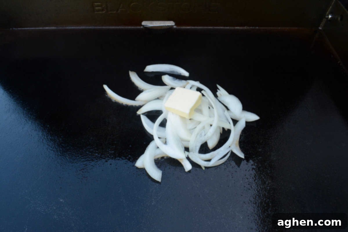 The Ultimate Blackstone Smash Burgers 4 sautéing onions on the blackstone