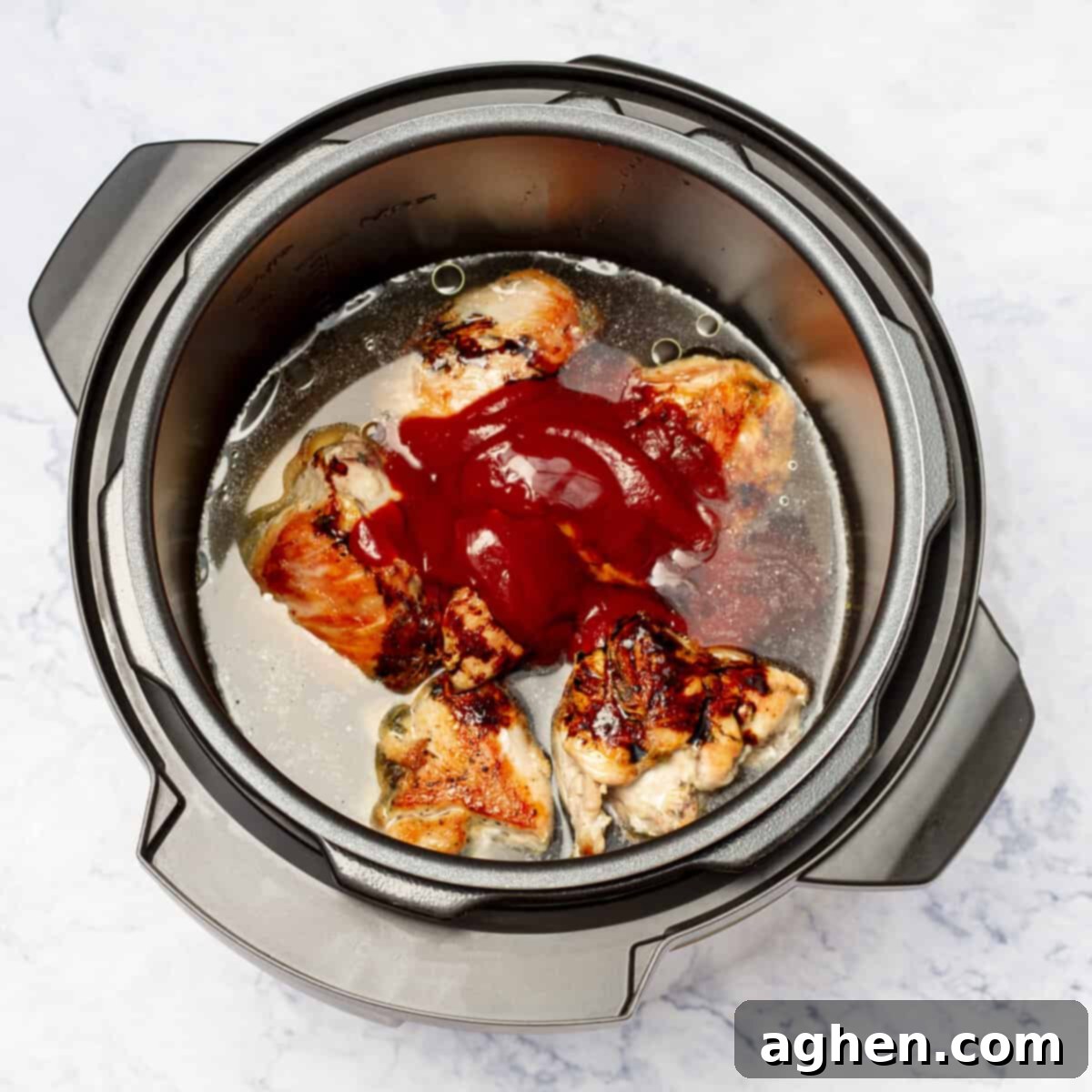 Sticky Honey Garlic Instant Pot Chicken 6 Instant pot having seared chicken, tomato sauce, soy sauce and chicken broth
