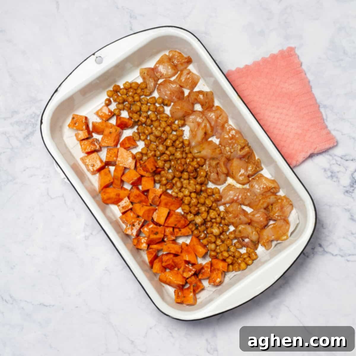 Weight Watchers Guide to Crafting the Ultimate Buddha Bowl 6 Roasted chicken cubes, chickpeas, and sweet potatoes on a baking tray