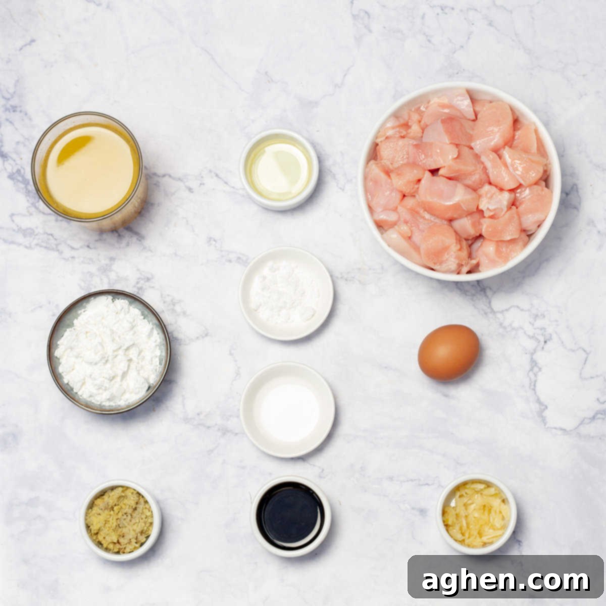 Lightened-Up Weight Watchers Orange Chicken 3 Fresh ingredients laid out for homemade orange chicken, including chicken, oranges, garlic, and spices.