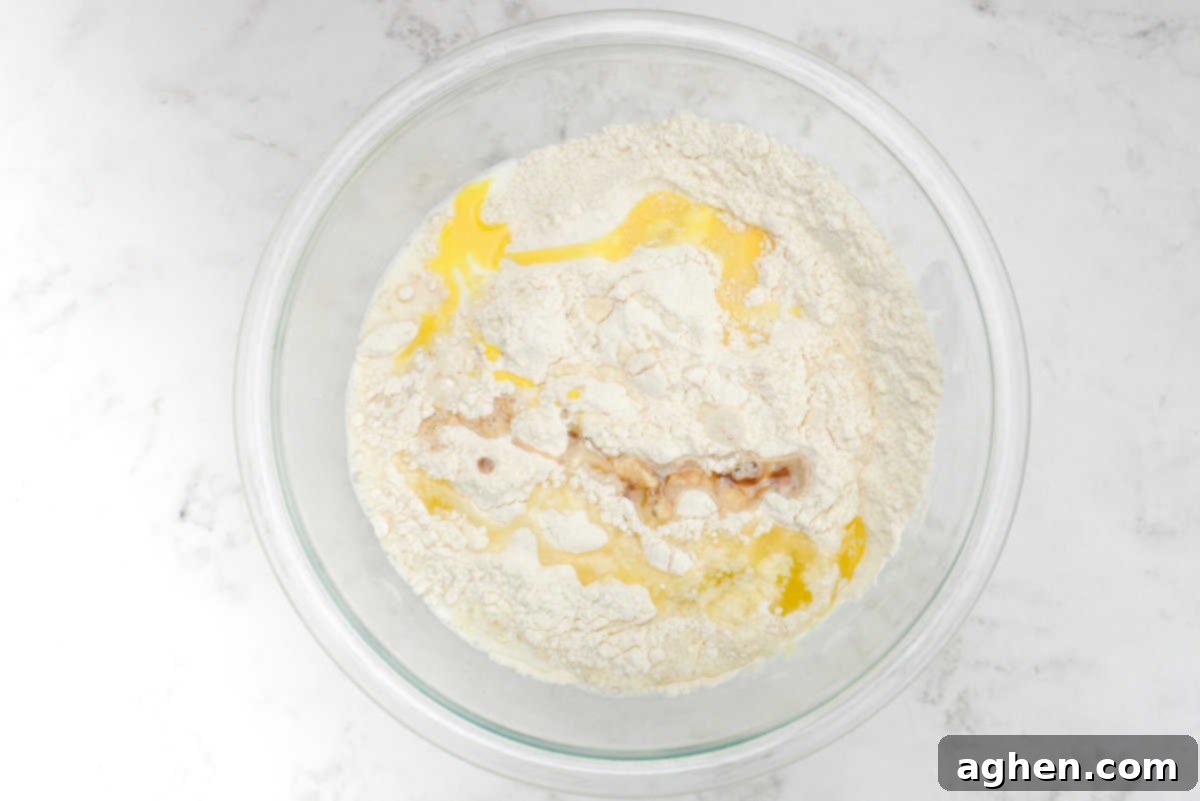 Blackstone Pancake Perfection: Your Ultimate Guide 6 blackstone pancakes wet ingredients added to the bowl of dry ingredients