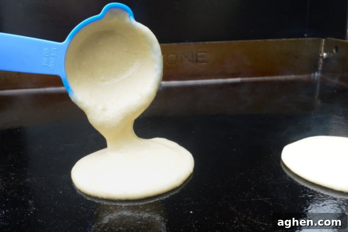 Blackstone Pancake Perfection: Your Ultimate Guide 8 pouring pancake batter onto hot blackstone griddle