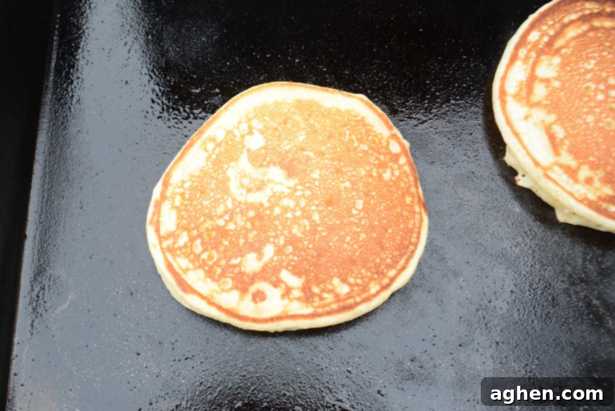 Blackstone Pancake Perfection: Your Ultimate Guide 10 flipped pancake, showing golden brown exterior.