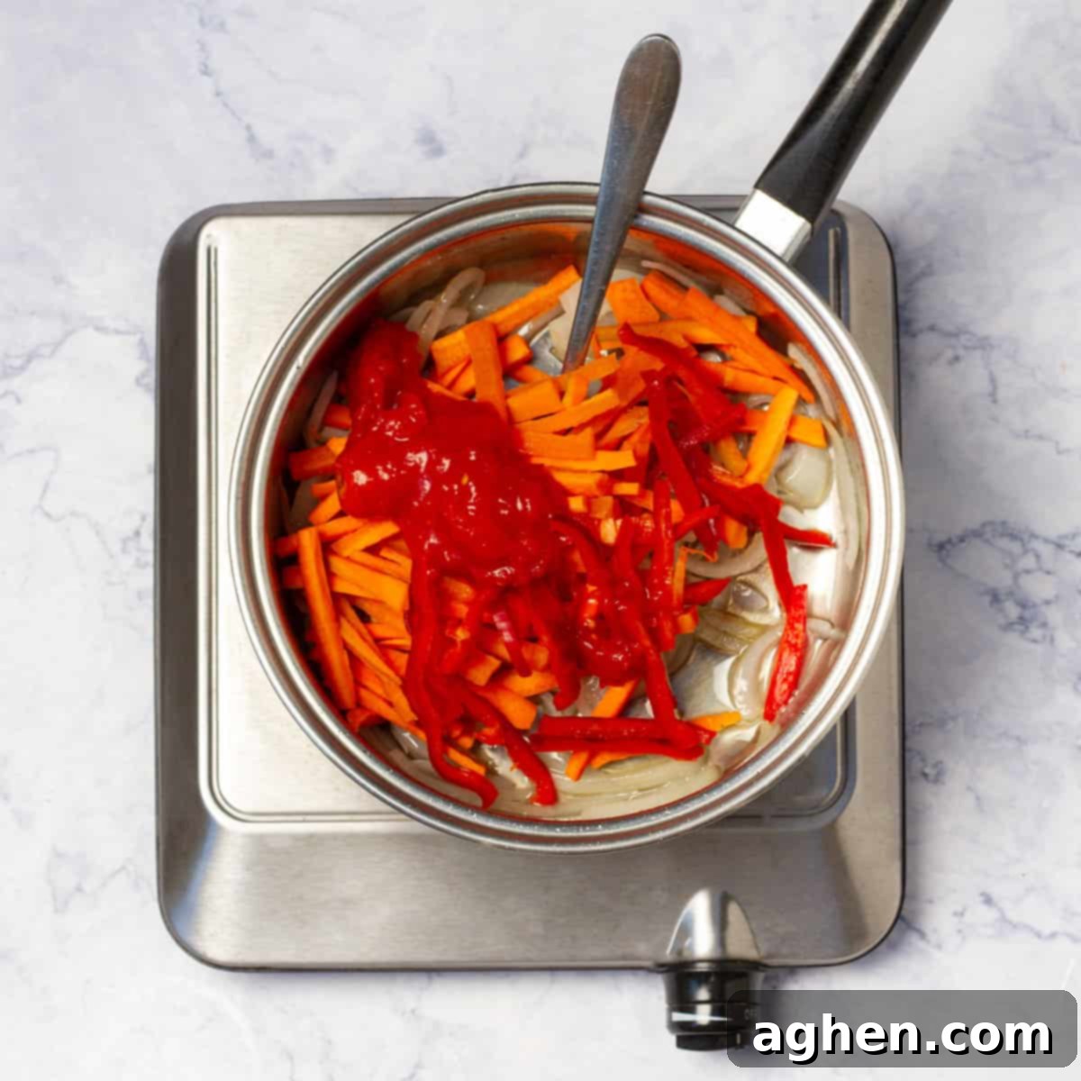 Mastering Mouthwatering Stuffed Fish 6 Cooking sliced onion, red bell pepper, and carrot in a skillet