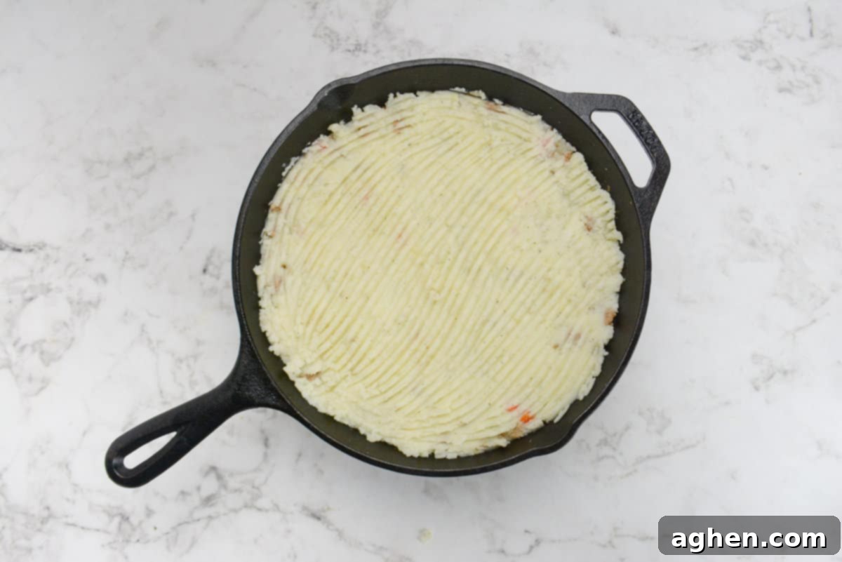 Weight Watchers' Timeless Ground Turkey Shepherd's Pie 9 A cast iron skillet of the unbaked Turkey Shepherd's pie.