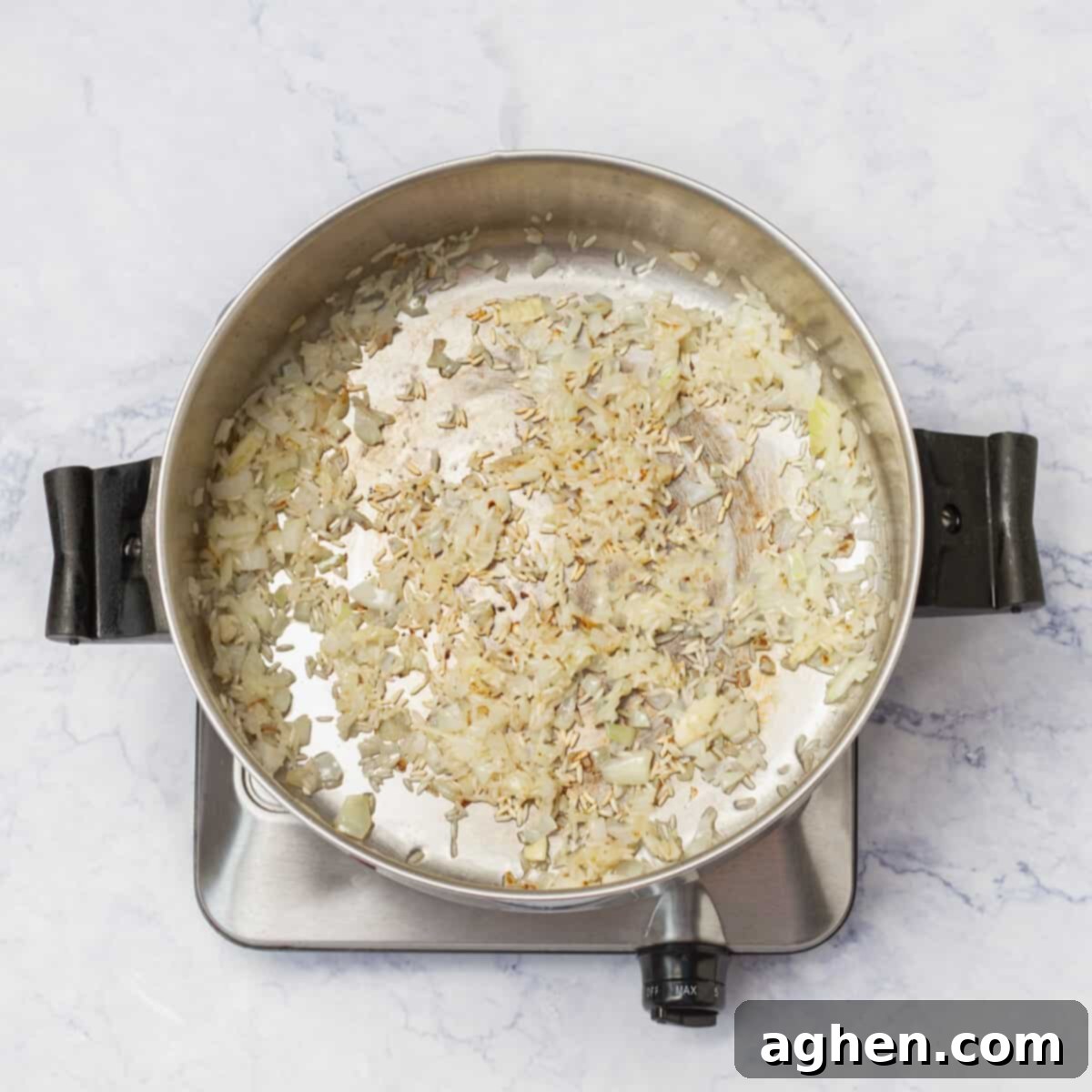 Chopped onion sautéing in a large pot over medium heat